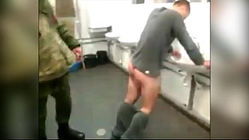 Russian soldier in his agreement beat the belt on the ass